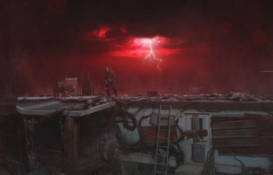 Young man standing on a roof of a rundown house playing electric guitar under a dark, red sky with lightning flashes in the background.